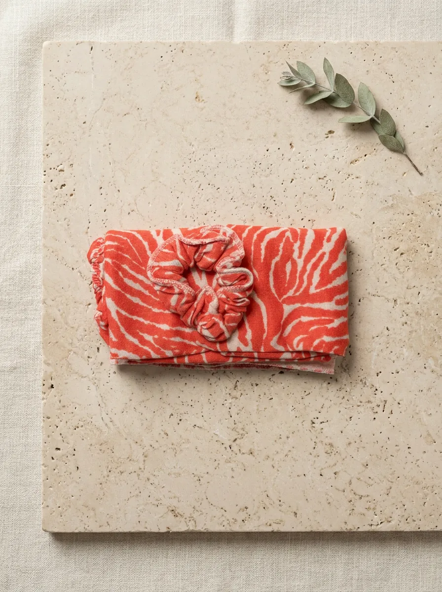 Folded turban on cream linen surface